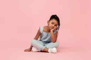 Free photo happy longhair brunette little girl isolated on pink studio background looks happy cheerful sincere copyspace childhood education emotions concept