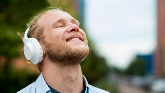 Happy man enjoying music on headphones