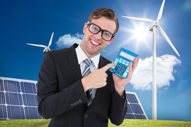 Free photo happy man holding a calculator and a solar panel background