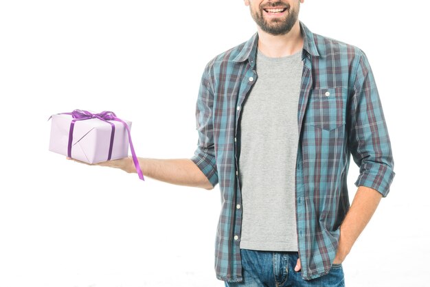 Happy man holding gift on white background