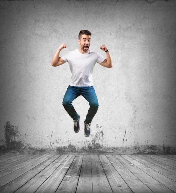 Free Photo happy man jumping on the wooden floor