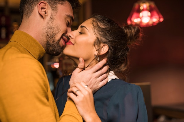 Happy man kissing cheerful woman 