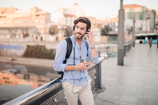 Free Photo happy man listening to music with mobile phone