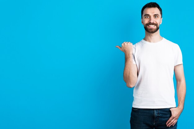 Happy man pointing next to him