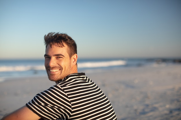 Happy man relaxing on the beach