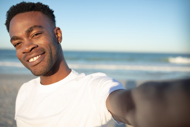 Happy man standing on the beach