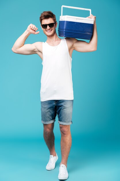 Happy man standing over blue isolated .