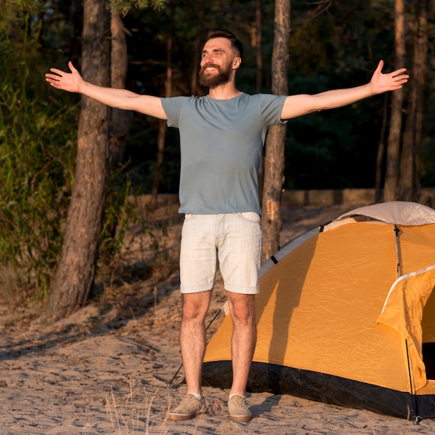 Happy man standing  with opened arms 