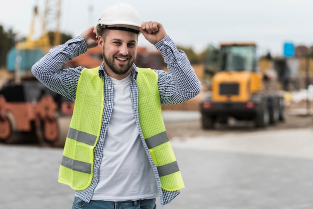 Free photo happy man wearing safety helmet