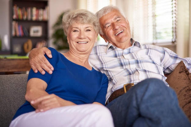 Happy mature marriage sitting on the sofa