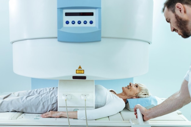 Free Photo happy mature woman having abdomen mri scan examination in the hospital