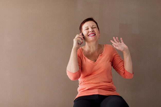 Happy mature woman laughing on the phone