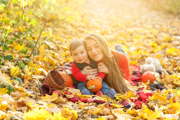 Happy mom and son on a picnic blanket