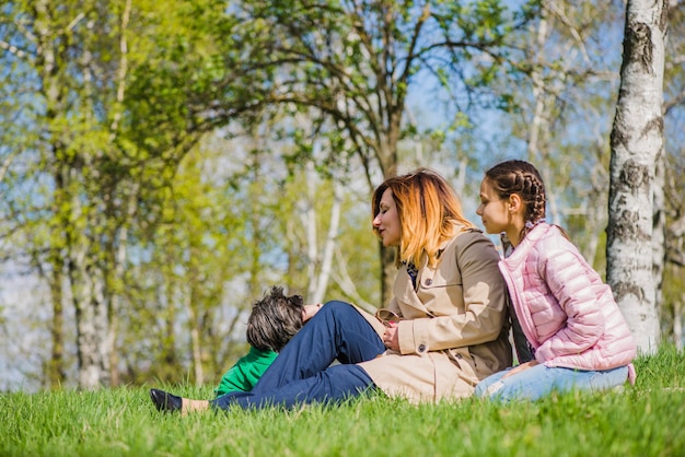 Happy mother and daughter with dog in park