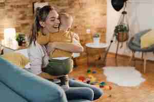 Free photo happy mother embracing her small son at home