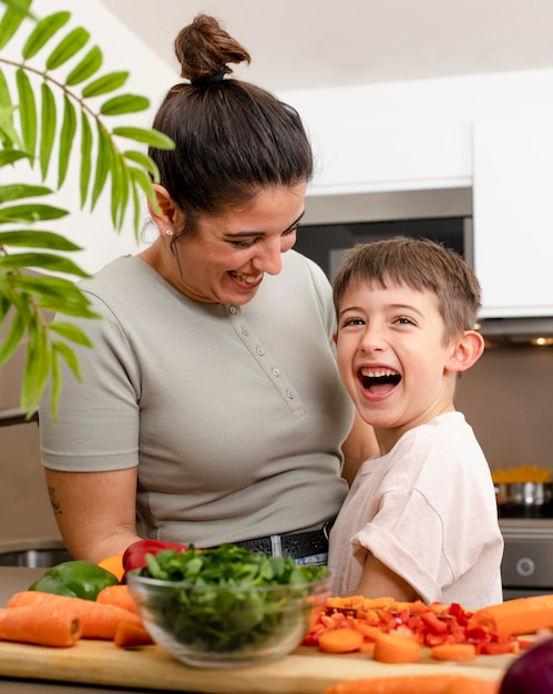 Happy mother and kid in kitchen medium shot