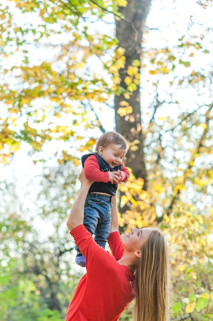 Happy mother playing with little boy