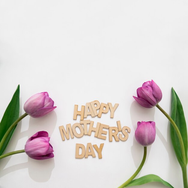 Happy mother's day lettering and four tulips