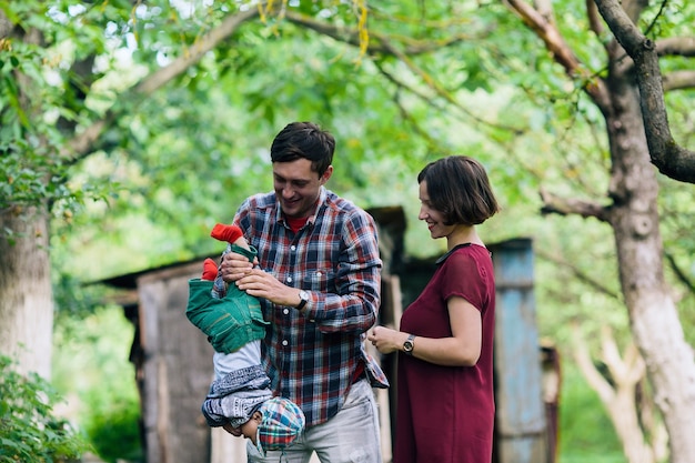 Happy mother watching man playing with baby