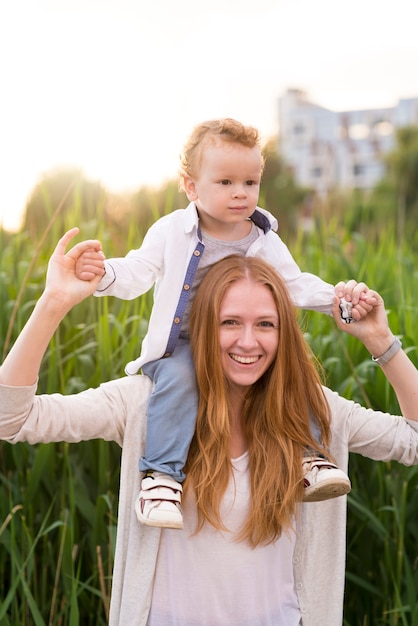 Free photo happy mother with kid in nature