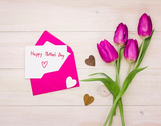 Happy Mothers Day inscription in envelope with tulips