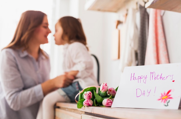 Free photo happy mothers day inscription near mother and daughter