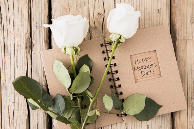 Happy Mothers Day inscription in notebook with roses