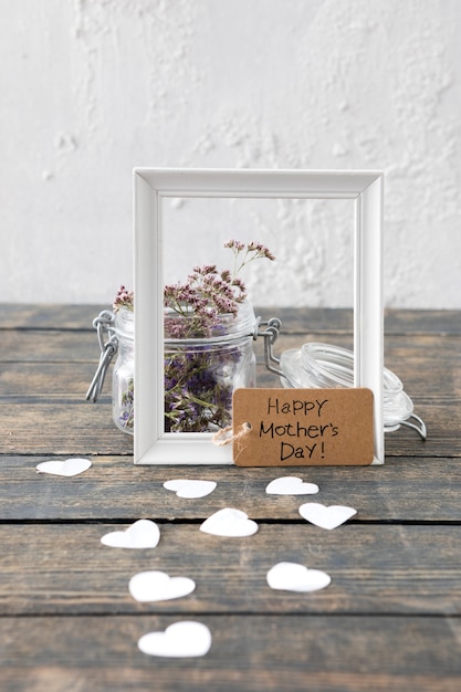 Free photo happy mothers day inscription with flowers and frame