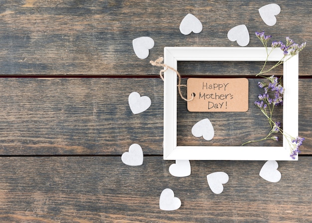 Free Photo happy mothers day inscription with flowers and small hearts 