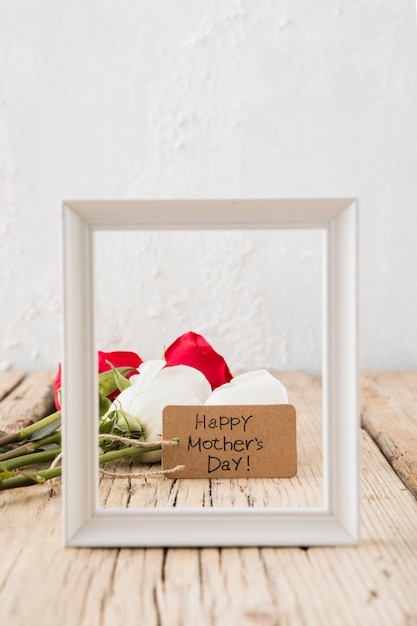 Free photo happy mothers day inscription with roses and frame