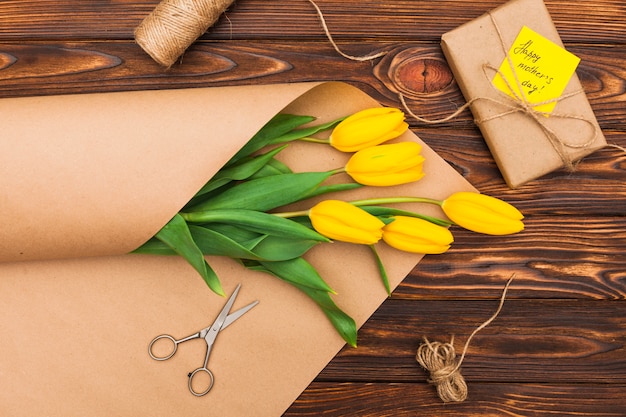 Happy Mothers Day inscription with tulips and gift