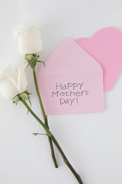 Free Photo happy mothers day inscription with two roses 