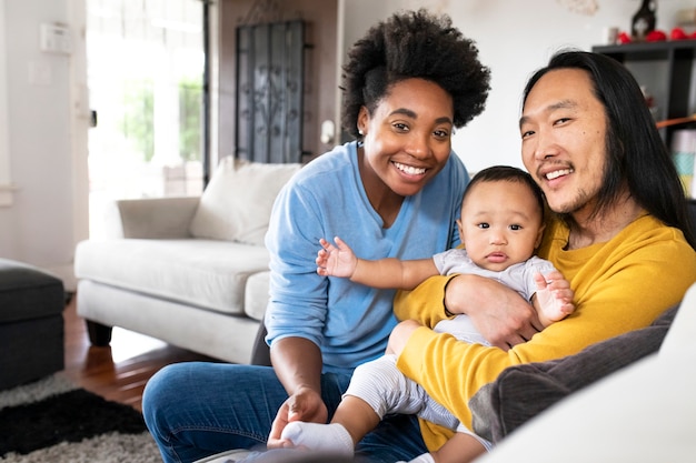 Free photo happy multiracial parents spending time with their son