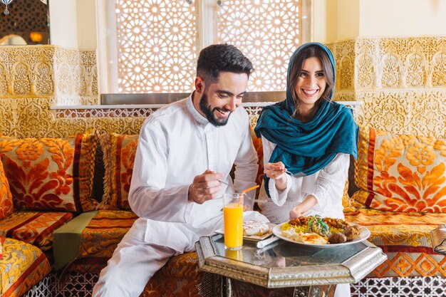 Happy muslim couple in arab restaurant