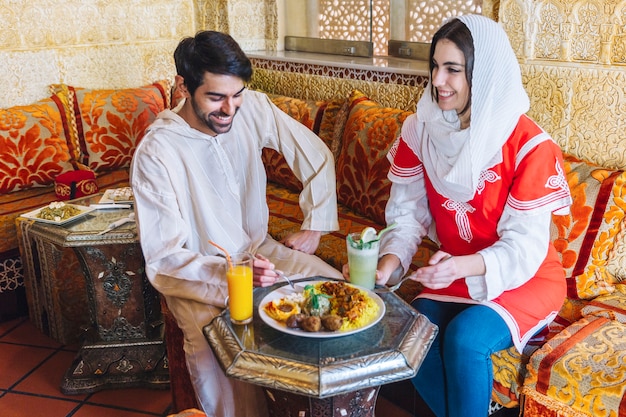 Free Photo happy muslim couple in restaurant