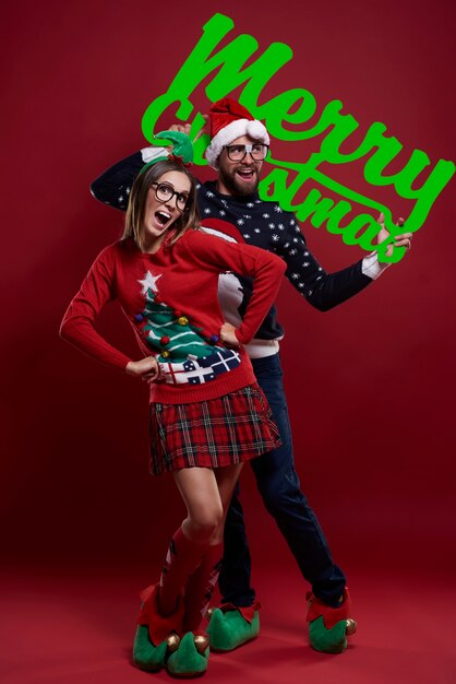 Happy nerd couple in Christmas clothes isolated