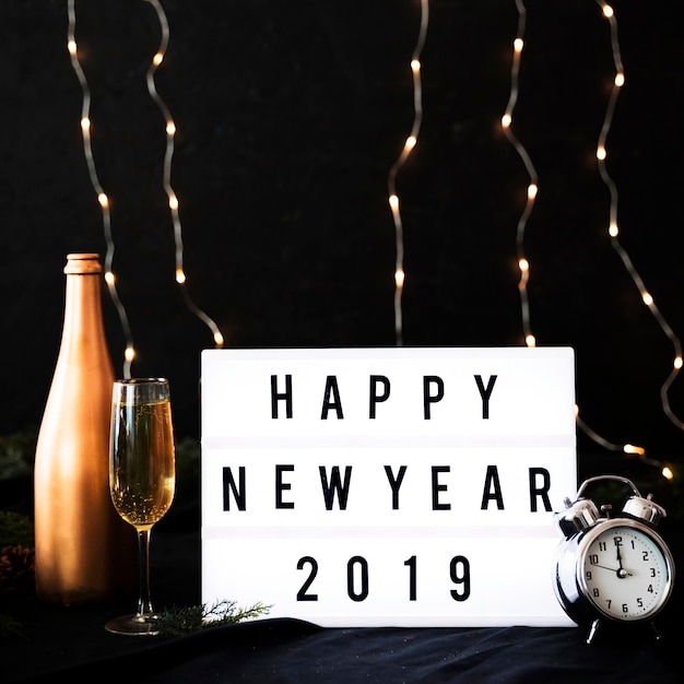 Free photo happy new year 2019 inscription on board with clock