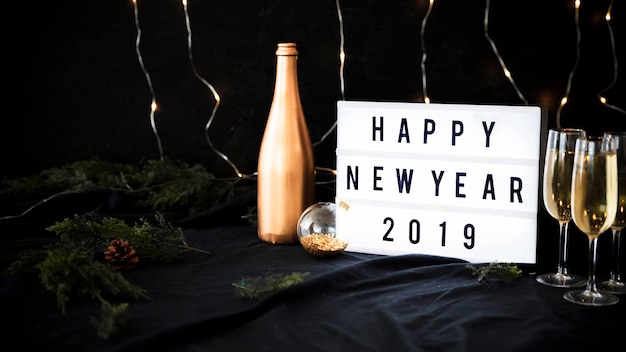 Free Photo happy new year 2019 inscription on board with glasses 