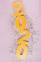 Free photo happy new year with golden numbers 2020 and silver glitter