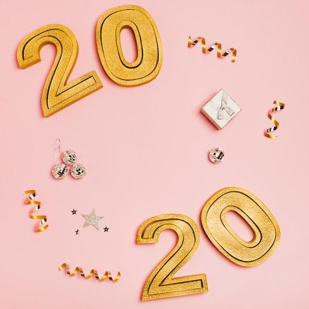 Free Photo happy new year with numbers 2020 on pink background