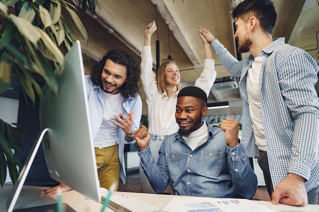 Happy overjoyed business team celebrate corporate victory