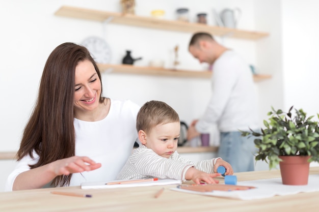 Happy parents in the kitchen with child