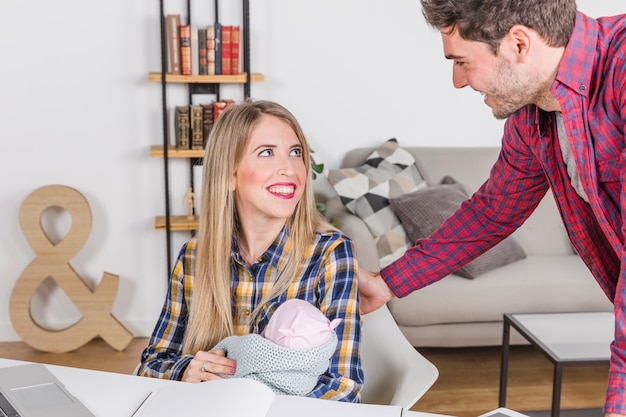 Happy parents with baby looking at each other