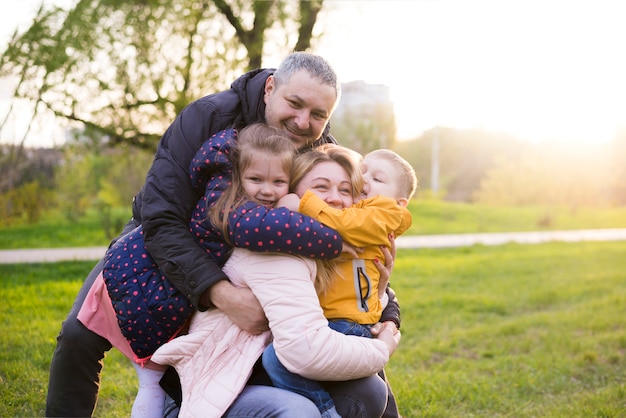 Free photo happy parents with kids in nature