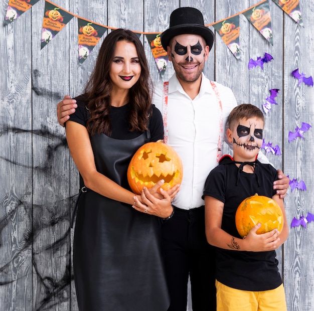 Happy parents with son posing for halloween