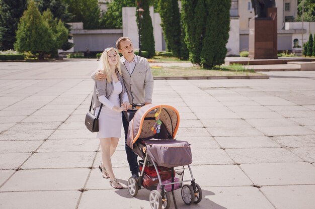 Happy parents with a stroller