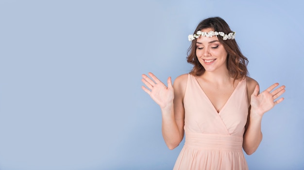 Happy passionate lady in dress with white flowers on head