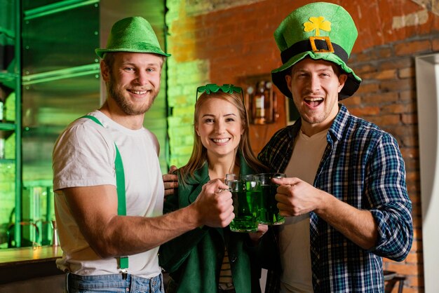 Happy people celebrating st. patrick's day at the bar