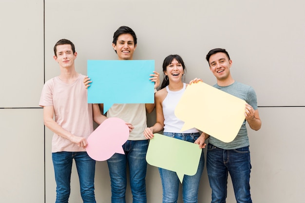 Happy people holding speech bubbles