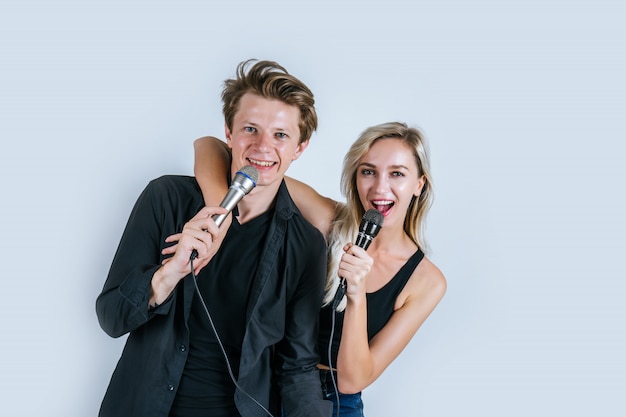 Happy portrait of Couple holding microphone and sing a song